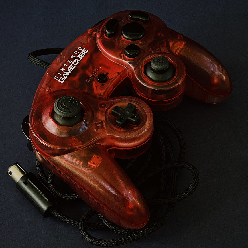 Red gaming controller on a black background